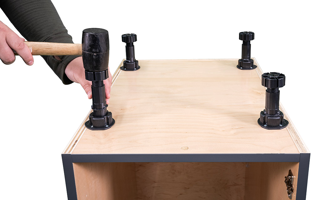 Step 12 photo showing hammering levelers into each socket