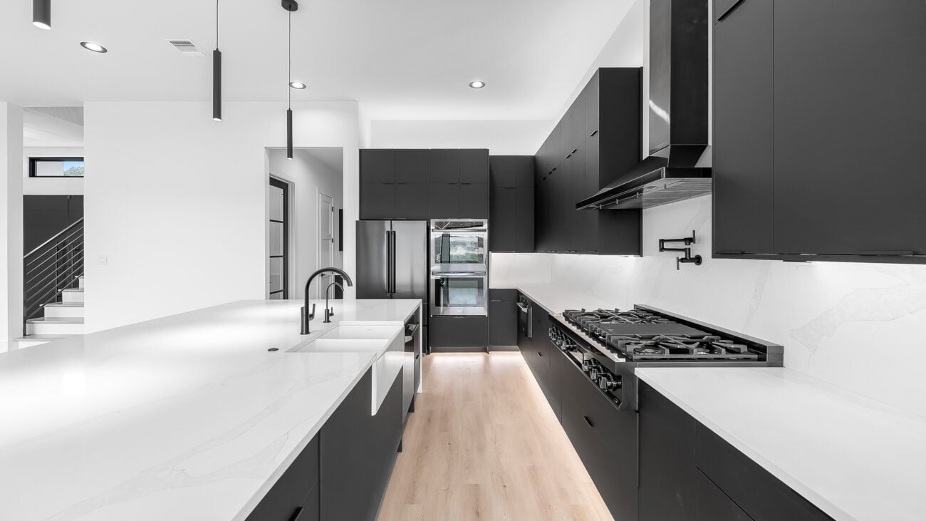 Ultra Modern kitchen with black cabinets and appliances